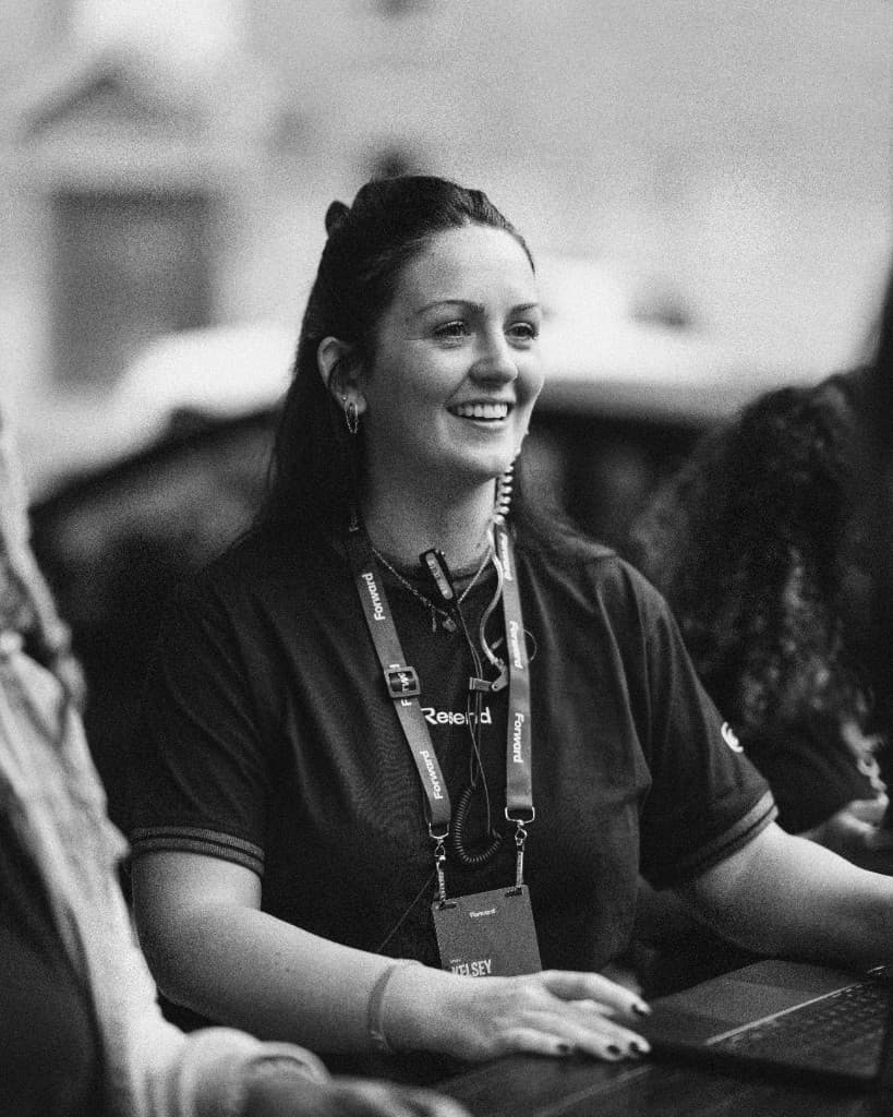 A Resend crew member smiling at the check-in desk