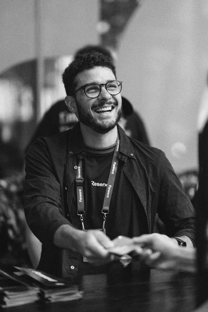 A Resend crew member handing out a badge at registration