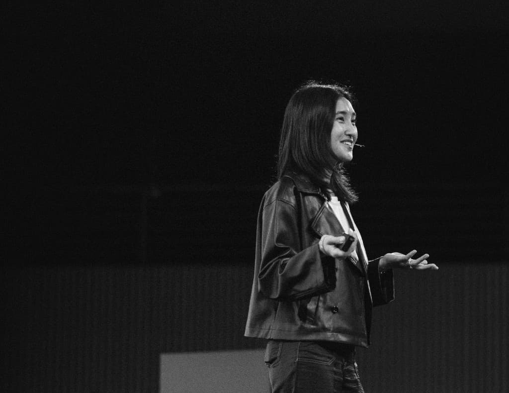 A speaker smiling on stage