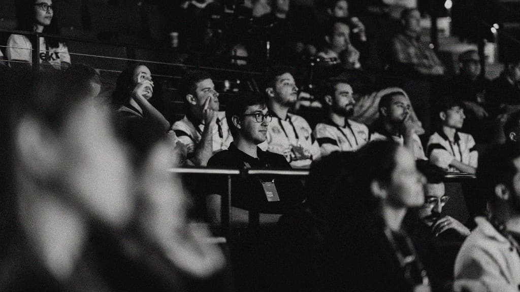 Attendees in the dark auditorium listening to a talk