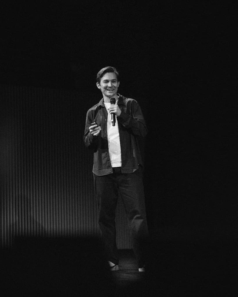 A speaker holding a microphone on the main stage