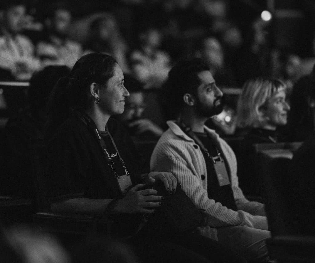 Attendees watching a talk from their seats