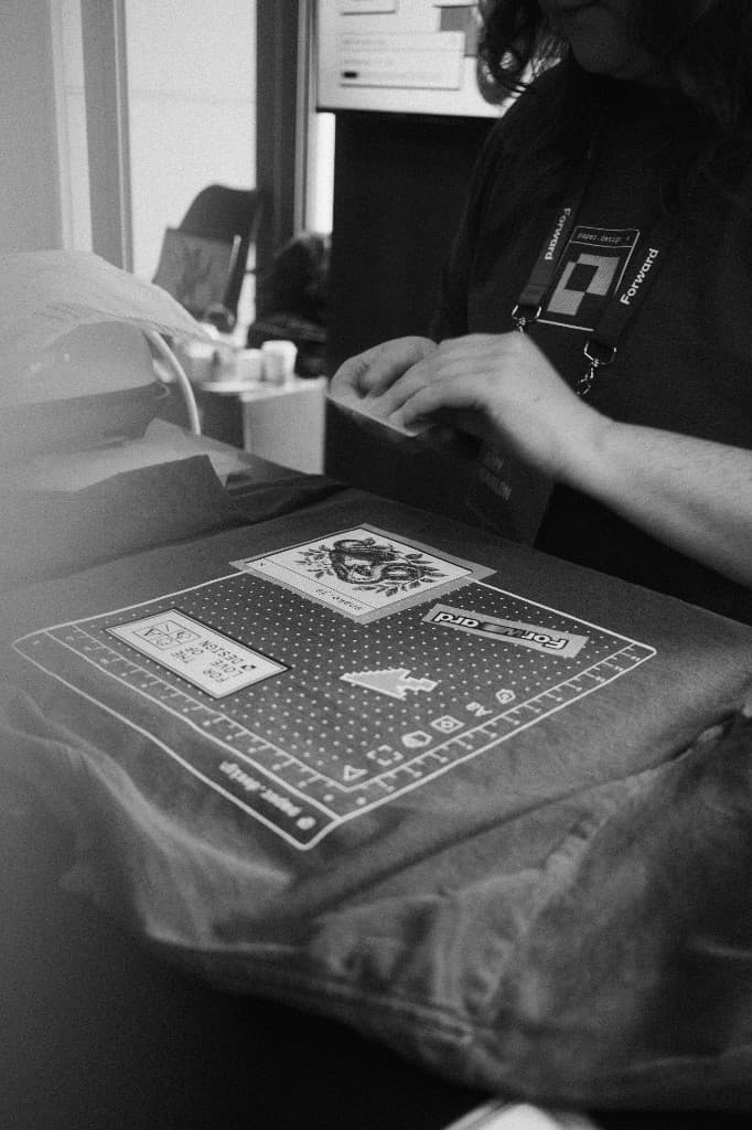 A custom T-shirt being printed at the merch counter